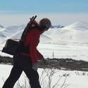 Sarah carries a tram battery to the Imnavait Creek transect